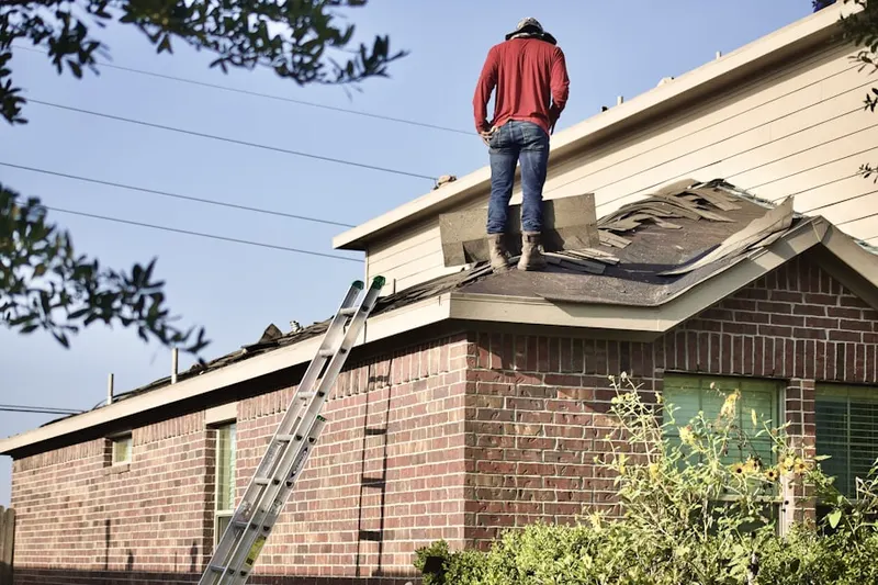 Professional roofer working on a residential roof in Lemont